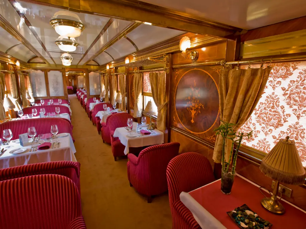 Interior of a luxury historic train carriage with polished wood and elegant seating