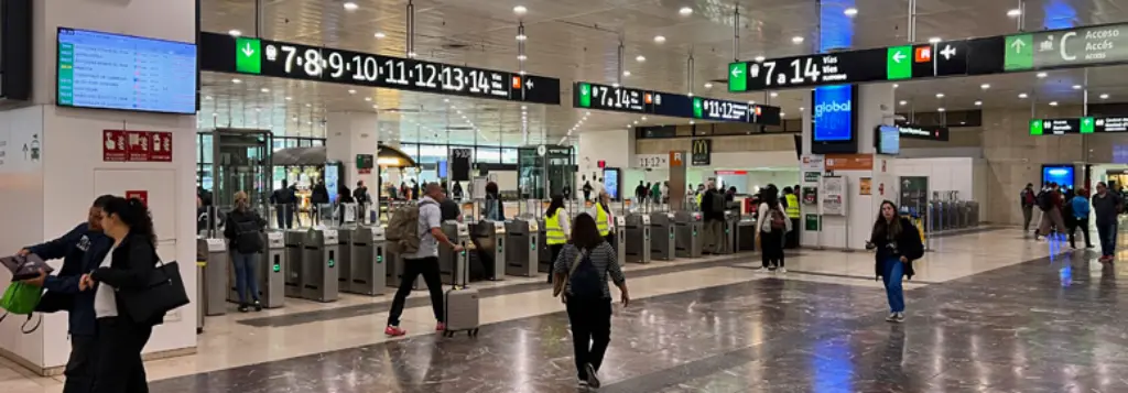 Interior concourse of Barcelona Sants train station with departures board