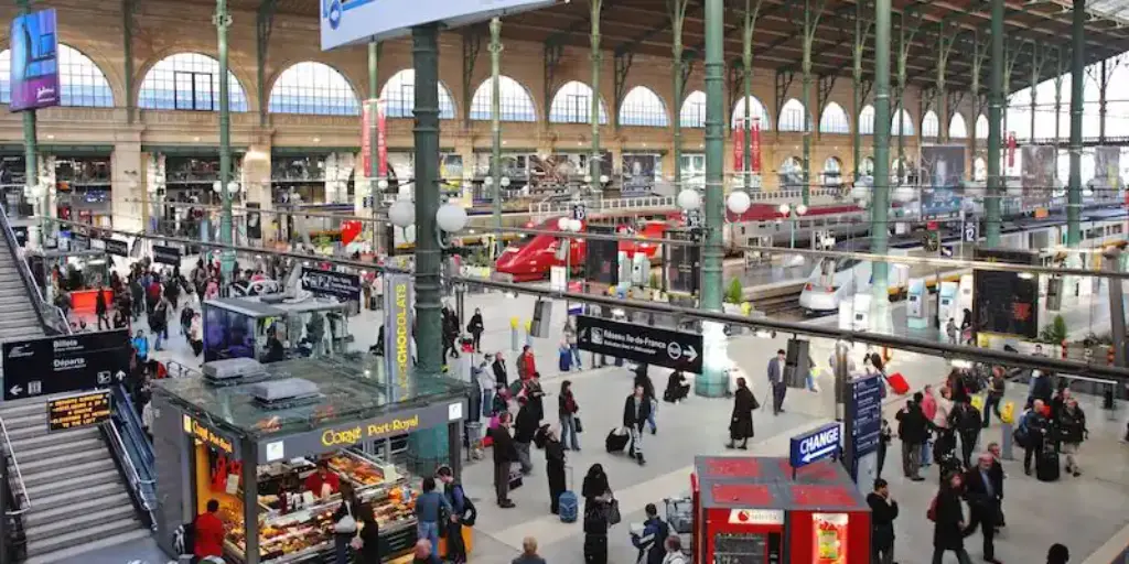 Paris Gare du Nord concourse with departure boards and travelers